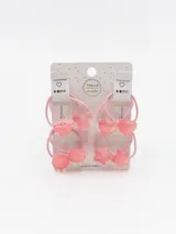 Pack de cuatro gomitas de pelo rosadas con dijes de plástico transparente en forma de corazón, estrella, oso y óvalo.