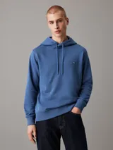 Buzo con capucha Calvin Klein color azul, de felpa de algodón y poliéster. Tiene corte regular, puños y bajo de canalé, capucha con cordón y logo bordado en el pecho.