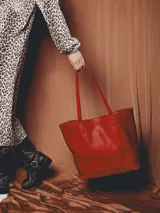 Bolso tote color beige de cuero, con broche, bolsillo interior y porta llaves.