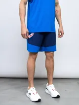 Short de entrenamiento azul marino y azul eléctrico, con escudo del Club Nacional de Football estampado en el lateral.