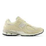 Championes de running color beige, con tecnología de amortiguación y parte superior de malla y ante.