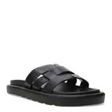 Sandalias chatas negras con tiras anchas entrelazadas.