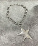 Collar plateado con cadena de eslabones grandes y dije de estrella de cinco puntas.