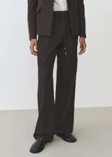 Pantalón cargo marrón oscuro de corte recto, con cintura elástica ajustable con cordón, bolsillos laterales, bolsillos de parche con solapa en la pierna y trabillas.