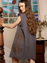 Vestido corto gris con bordado floral en el frente, corte holgado y mangas cortas.