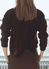 Sweater marrón de punto medio con cuello redondo y mangas largas.