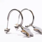 Aros tipo argolla de acero color plateado con dije colgante de estrella dorada.