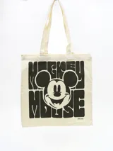 Bolso tipo tote bag de lona color crema con asas largas y estampado de Mickey Mouse en negro.