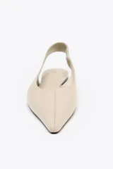 Zapato tipo bailarina destalonada color beige, con puntera fina y tira trasera elástica.