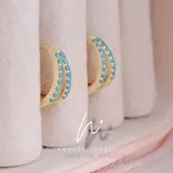 Aros de plata starlina con baño de oro, adornados con zirconias turquesa.