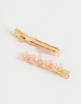Set de dos hebillas para el pelo doradas con apliques de flores de resina color rosa y perlas.