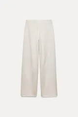 Pantalón de tiro alto color beige, con cintura elástica y pierna recta.