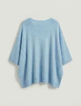 Poncho tejido de punto grueso, color mostaza/mostaza oscuro, con cuello redondo y caída amplia.