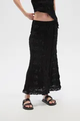 Falda larga negra de broderie y poliamida, corte recto.