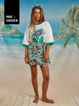 Minifalda estampada con flores en tonos verde, blanco y negro. Diseño cruzado con nudo lateral.