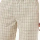 Bermuda de hombre con estampado a cuadros en tonos beige y blanco, con cintura elástica ajustable con cordón y logo de la marca en la pierna izquierda.
