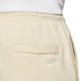 Pantalón de jogging color crema, de corte ajustado, con cintura elástica y cordón ajustable. Tiene bolsillos laterales y logo de Nike bordado en blanco en el muslo izquierdo.