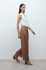 Pantalón negro de vestir, tiro alto, con pinzas frontales y corte ancho y holgado.