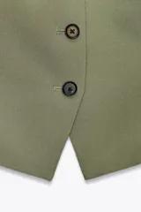 Chaleco verde oliva de Zara Woman Collection, con escote en pico, sin mangas y cierre frontal con botones negros.
