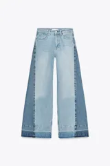Pantalón de jean de tiro medio con cinco bolsillos, corte wide leg y detalle de tejido con lavado lateral combinado. Cierre frontal con cremallera y botón.
