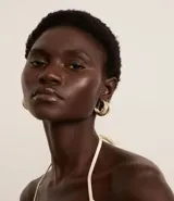 Par de caravanas tipo aros con revestimiento brillante color dorado. Cierre con tornillo. Fabricado con metal reciclado.