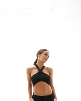 Top negro con escote cruzado, confeccionado en algodón con lycra, diseño ajustado.