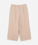 Pantalón de corte ancho confeccionado en sastrería de viscosa color beige, con cintura alta, trabillas, cierre con botón forrado y bolsillos laterales.