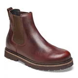 Bota Chelsea de cuero color marrón oscuro (chocolate) con elásticos laterales marrones y suela gruesa dentada de color marrón.