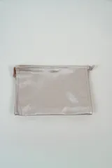 Neceser de tela sintética color lila, con cierre superior y asa lateral.