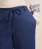 Pantalón largo de lino color azul con corte palazzo, cintura alta con elástico y cinturón de cordón ajustable.