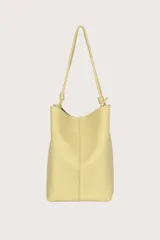 Bolso hobo amarillo con textura granulada y correa de hombro fina con nudos.