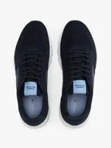 Zapatillas deportivas bajas de running Tommy Hilfiger, color azul marino, con exterior de punto canalé transpirable y suela gruesa de EVA blanca. Presentan cordones y plantilla extraíble.