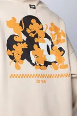 Buzo canguro negro de algodón friza, corte oversize y estampa de Mickey Mouse con detalles en verde.