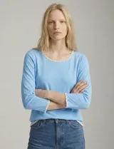 Remera de manga tres cuartos color celeste, confeccionada en modal con elastano. Presenta un aplique de bordado blanco en el escote redondo y en los puños.
