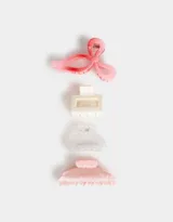 Set de cuatro broches para el pelo de diferentes formas y colores: uno con forma de moño rosa y rojo, uno rectangular color crema, uno transparente y uno con forma de media luna rosa marmolado.