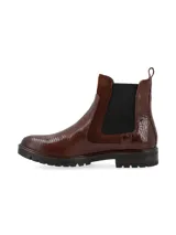 Botín de caña corta color negro, de origen europeo, con combinación de materiales: cuero croco, cuero snake y cuero nobuk. Presenta elásticos laterales al tono y forro de pelo sintético.