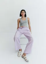 Pantalón wideleg color lila con rayas verticales, de tejido mezcla de poliéster y lino. Tiene trabillas, dos bolsillos laterales y dos bolsillos de ribete en la parte posterior.