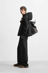 Pantalón wide fit confeccionado en tejido de algodón con interior en rizo, color negro. Cintura elástica ajustable con cordón interior, bolsillos frontales y detalle de bolsillo trasero de vivo. Perneras con costura frontal y efecto lavado.