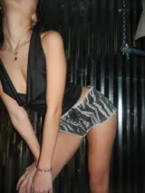 Short de jean con estampado de cebra en tonos grises, tiro alto, corte ajustado, ruedo desflecado y ajuste frontal con cordones.