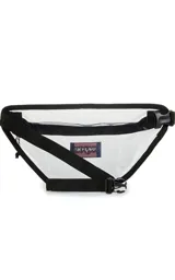 Riñonera transparente con ribetes negros y logo de JanSport en el frente. Tiene un compartimento principal con cierre y correa ajustable con hebilla.