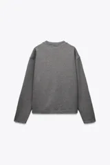 Sweater color crudo de cuello redondo y manga larga.