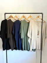 Remerón italiano confeccionado en bambula color naranja, con escote en V y calce oversized. Incluye collar largo con cuentas de colores y dije de estrella.