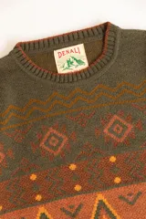 Buzo tejido con cuello redondo, mangas largas y diseño con motivos geométricos en tonos marrón, naranja y verde.