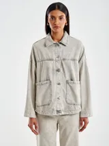 Chaqueta denim gris con botones en la delantera y dos bolsillos sin solapa tambien en el frente. Cuello camisero.