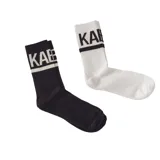 Par de medias blancas y negras con logo Kaboa en la parte superior y una franja horizontal.