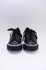 Zapatillas bajas color marrón con textura simil cuero de cocodrilo, cordones al tono y suela de goma blanca con detalle marrón.