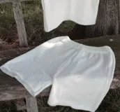 Conjunto tejido de algodón color blanco, compuesto por un top corto y un short con cintura elástica.