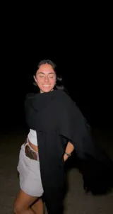 Ruana de lana merino negra, con diseño abierto y tejido suave.