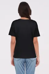 Remera negra con estampado frontal y manga corta, de corte holgado.