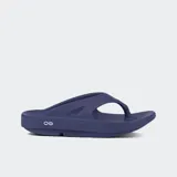 Sandalias tipo ojota de color azul marino, con suela gruesa y ergonómica que ofrece alta absorción de impacto y soporte de arco. Presentan un diseño minimalista con un logo circular en el lateral.